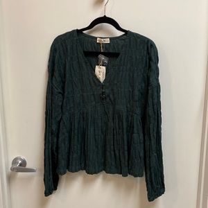 Pull over empire waist top. Three covered buttons at the top of the top.